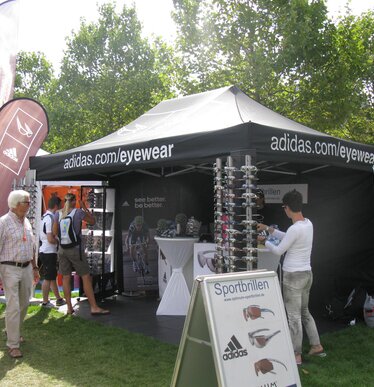 Donkerblauwe 3x3 m opvouwbare gazebo met witte Husqvarna logo en gesloten blauwe zijwand voor bos- en tuinproductententoonstelling - Ecotent