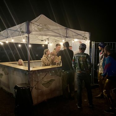 Vijf rode 8x4 m gazebos aan de rand van een olympisch buitenzwembad